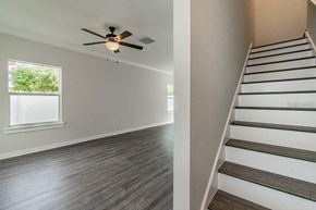Tampa apartment for rent - a living room with a staircase and a ceiling fan