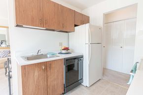 Ballwin apartment for rent - a kitchen with a sink and a refrigerator