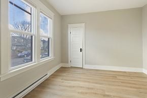 Tacoma apartment for rent - an empty room with a door and two large windows