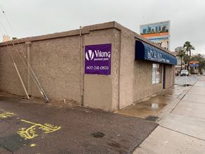 Phoenix apartment for rent - a building with a purple sign on the side of a street