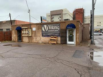 Phoenix apartment for rent - a small building with a vinig pharmacy sign on the side of a street