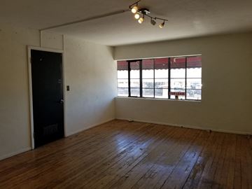 Phoenix apartment for rent - an empty living room with a window and wooden floors