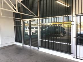 Phoenix apartment for rent - a car parked outside of a building with a gate on it