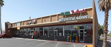 Phoenix apartment for rent - the front of a store with a parking lot and palm trees