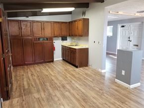 Phoenix apartment for rent - an empty kitchen with wood flooring and wooden cabinets