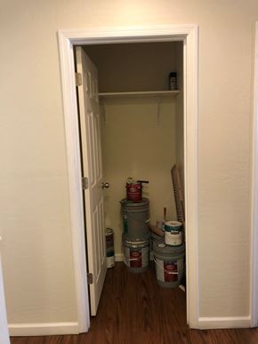 Phoenix apartment for rent - the pantry door is open to a small closet with paint buckets