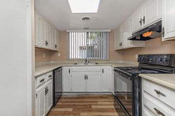 Phoenix apartment for rent - a kitchen with white cabinets and a stove and a sink