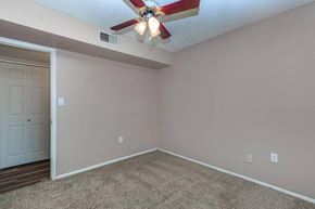 Phoenix apartment for rent - a bedroom with a ceiling fan and a door