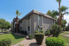 Phoenix apartment for rent - a building with palm trees in front of it