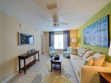 Jacksonville apartment for rent - A living room with a white couch and a coffee table.