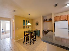 Jacksonville apartment for rent - Dining room staged with table, wall art, pendent lighting, and wall art