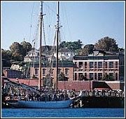 Port Townsend apartment for rent - A boat is docked in a harbor with a building in the background.
