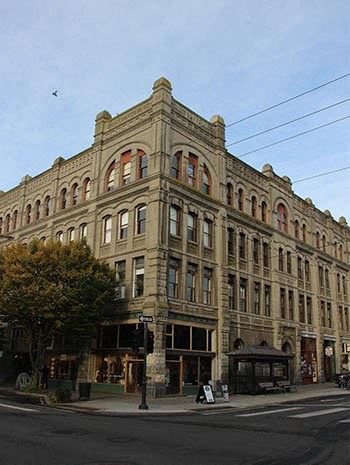 Port Townsend apartment for rent - A large, old building with many windows sits on a street corner.