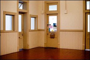 Port Townsend apartment for rent - A room with a wooden floor and a door with a basket on it.