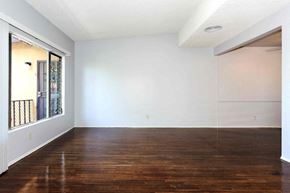 Los Angeles apartment for rent - A large empty room with wooden floors and white walls.