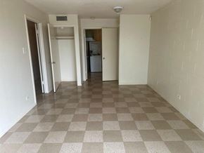 Laredo apartment for rent - an empty living room with a checkered tile floor
