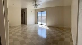 Laredo apartment for rent - A room with a checkered floor and a ceiling fan.
