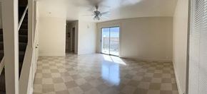 Laredo apartment for rent - A spacious room with a checkered floor and a ceiling fan.