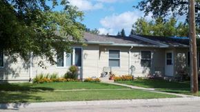 Rugby apartment for rent - a white house with a sidewalk in front of it