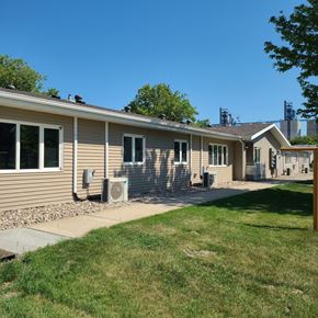 Rugby apartment for rent - a tan house with a sidewalk in front of it