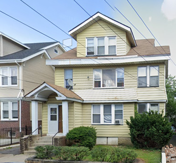 Newark apartment for rent - a yellow house with a brown roof on a street