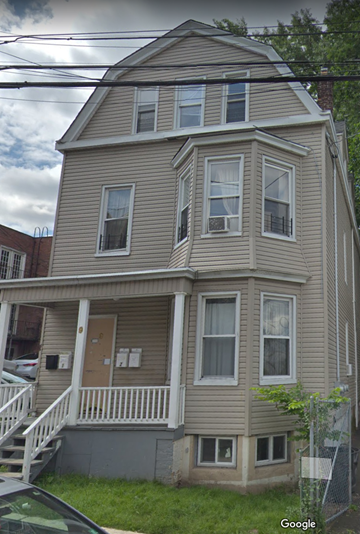 Irvington apartment for rent - the front of a tan house with white stairs