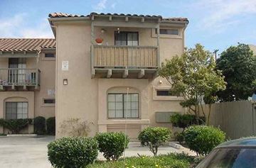 San Diego apartment for rent - an apartment building with a balcony and a car parked in front