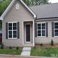 Wake Forest apartment for rent - a brown house with black shutters and a front porch