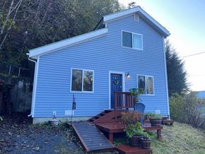 Sitka house for rent - A blue house with a porch and a deck.