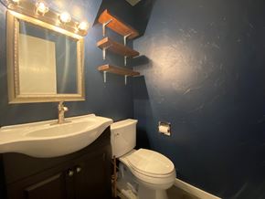 Sitka house for rent - A bathroom with a white sink and a white toilet.