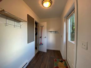 Sitka house for rent - A hallway with a broom leaning against the wall.