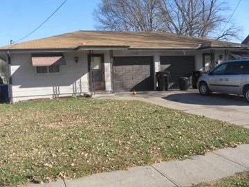 Fremont apartment for rent - A house with a garage and a car parked in front.