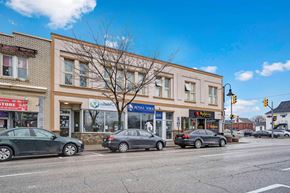 Oshawa apartment for rent - a city street with cars parked in front of a building