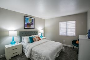 Las Vegas apartment for rent - A bedroom with a bed, nightstand, and chair.