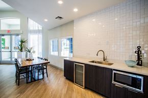 Las Vegas apartment for rent - A kitchen with a table and chairs and a sink.