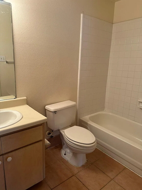 Laredo apartment for rent - A white toilet sits next to a sink in a bathroom.