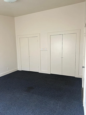 Laredo apartment for rent - A room with two white doors and a carpeted floor.