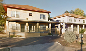 Laredo apartment for rent - A building with a red roof and a white building with a blue roof.