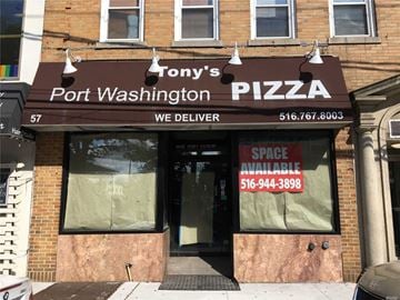 Port Washington apartment for rent - A brick building with a sign that says Tony's Port Washington Pizza.