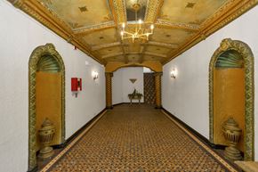 San Francisco apartment for rent - A hallway with a patterned floor and a chandelier hanging from the ceiling.