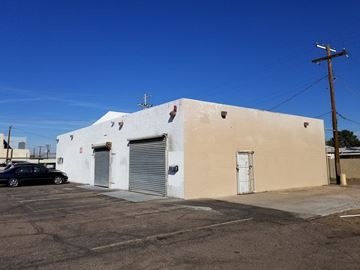 Phoenix house for rent - a white building with two doors and a parking lot