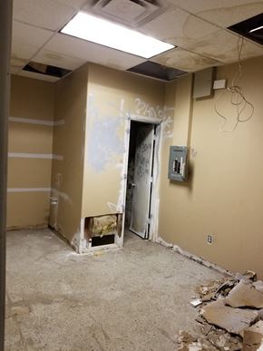 Phoenix house for rent - a room with a hole in the wall and a doorway