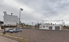 Phoenix house for rent - a parking lot with cars in front of an old building