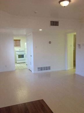 Phoenix apartment for rent - an empty living room with a kitchen in the background
