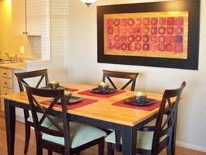 Oklahoma City apartment for rent - a dining room table with chairs and a painting on the wall