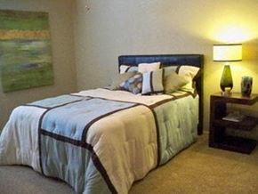 Oklahoma City apartment for rent - a bedroom with a bed and a lamp