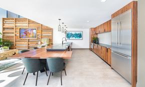 Orlando apartment for rent - a kitchen with stainless steel appliances and a wooden table