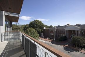 Raleigh apartment for rent - A view of a building with a walkway in front of it.