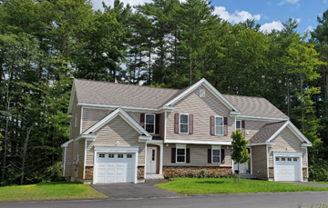 Concord apartment for rent - a house with two garage doors on the side of a street