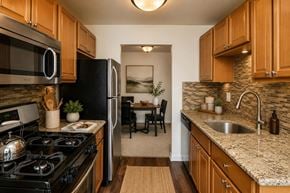 Glen Burnie apartment for rent - A kitchen with a black stove top oven and a black refrigerator.